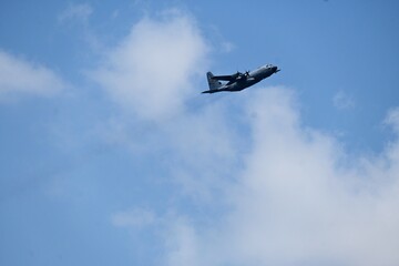 military plane flying through sky cloud