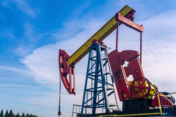 pumpjack on an oil well against the background of sky