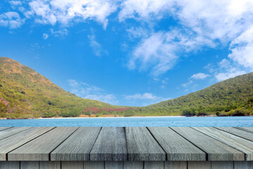 Empty wooden table on sea sky and mountain background.