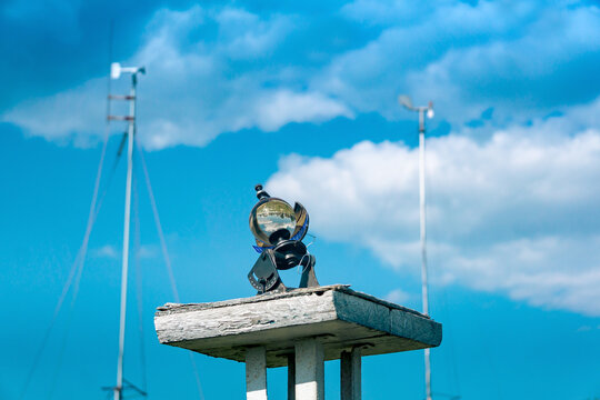 spherical meteorological sunshine recorder (heliograph) at the weather station against the sky