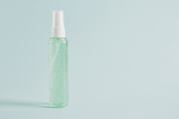 pump classic bottle with green gel inside, cosmetic container on light blue background