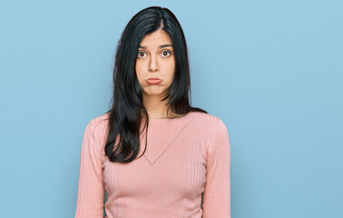 Young hispanic woman wearing casual clothes depressed and worry for distress, crying angry and afraid. sad expression.
