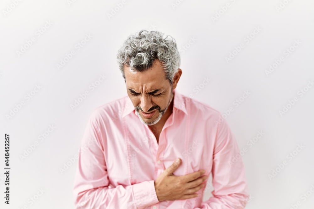 Sticker middle age hispanic man standing over isolated background with hand on stomach because nausea, painf