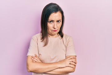 Obraz premium Middle age hispanic woman wearing casual clothes skeptic and nervous, disapproving expression on face with crossed arms. negative person.