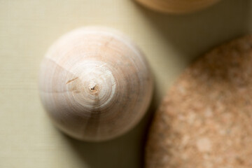 wooden object with out of focus cork coaster on light beige background 