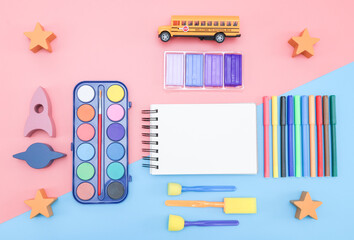 School supplies on pink and blue.
Set of accessories from: school bus, rocket, paints, felt-tip...