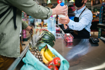 Man buing fresh vegetables and fruits at grocery store.