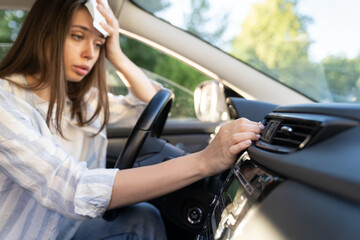 Girl driver has problem with a non-working conditioner, hand checking flow cold air, being hot...