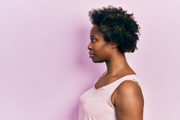 Young african american woman wearing casual sleeveless t shirt looking to side, relax profile pose...