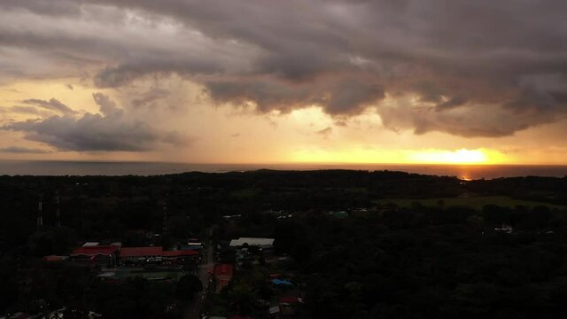 Uvita town aerial pacific ocean in background marino ballena park cloudy fire sunset 