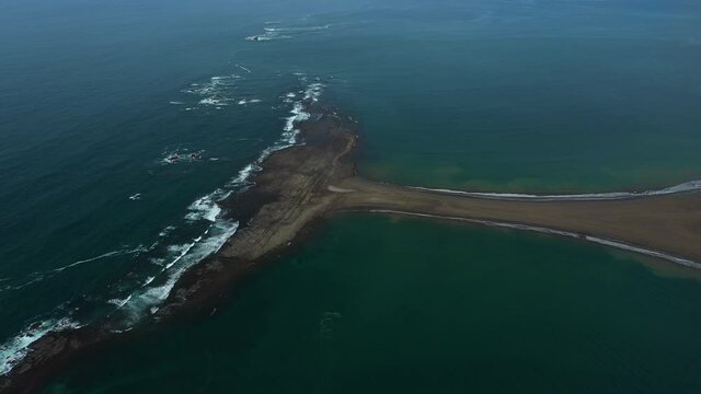 Aerial shot over Uvita Marino Ballena National Park reef whale tail shape cloudy day 