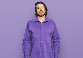 Middle age handsome man wearing business shirt relaxed with serious expression on face. simple and natural looking at the camera.