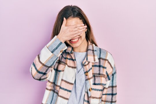 Young caucasian girl wearing casual clothes smiling and laughing with hand on face covering eyes for surprise. blind concept.