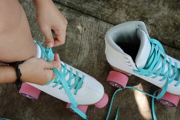 Close up of whith shoes rollerblade and leg on the road