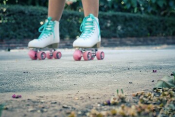 Close up of whith shoes rollerblade and leg on the road