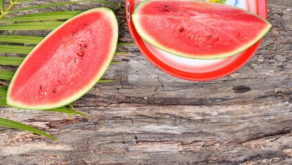 Red watermelon summer fruit on brown wood table background