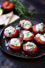 Fototapeta na wymiar Baked plums with blue cheese and thyme. Healthy snack. Keto food. 