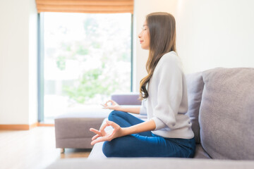 Portrait beautiful young asian woman meditation on sofa