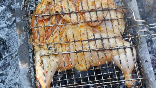 Whole juicy with spices grilled chicken tabaka or tapaka at summer picnic