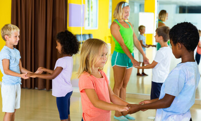 Little boys and girls dancing pair dance in the ballet studio. High quality photo