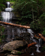 Water from a waterfall rushes down rocks, long exposure.