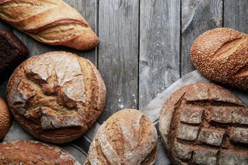 Assorted homemade gluten-free and yeast-free bread on grey wooden background. View from above.