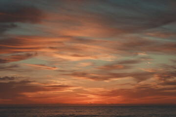 Fototapeta na wymiar A sunrise over a beach.