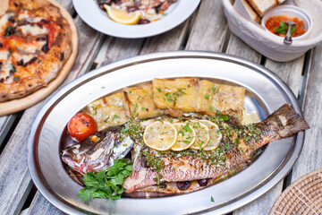 Baked fish with potatoes and sauce