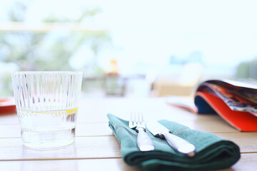 restaurant table setting, fork and knife on the table menu decor