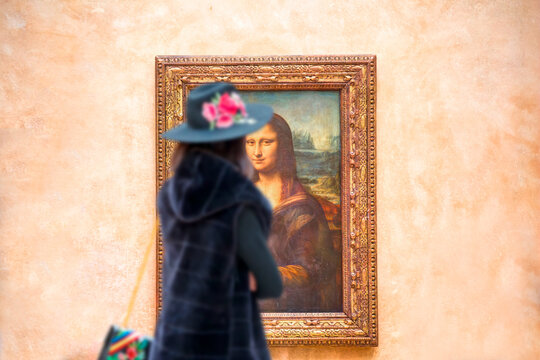 PARIS, FRANCE - FEBRUARY 06, 2016: Visitors take photo of Leonardo DaVinci's "Mona Lisa" at the Louvre Museum