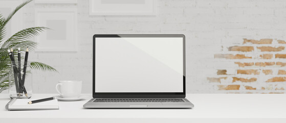 White-modern working space, blank screen smart tablet with keyboard, white brick wall