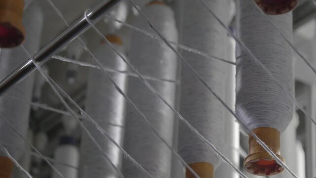 Closeup Shot Of Cotton Spools Weaving On A Industrial Spinning Machine