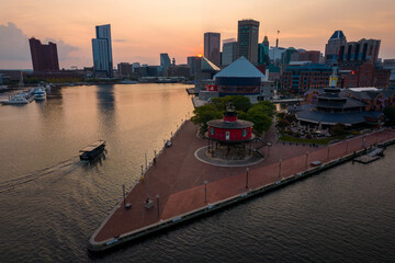Aerial View of Baltimore City Inner Harbor at Sunset with Boat Passing in the Water