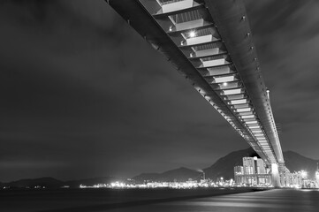 Cutterstone bridge and cargo port in Hong Kong city at night