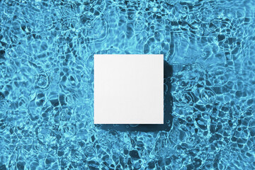 White square podium on the blue water surface background. Flat lay, copy space. 