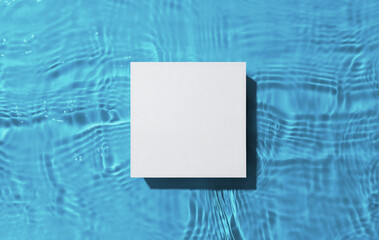 White square podium on the blue water surface background. Flat lay, copy space. 