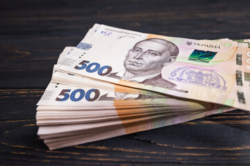 stack with 500 hryvnia on a wooden background.