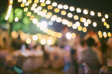 Foto op Canvas vintage tone blur image of food stall at night festival with bokeh for background usage. Festival Event Party with People Blurred Background. Blur people having sunset beach party in summer vacation © kanpisut