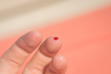 a drop of blood on a finger