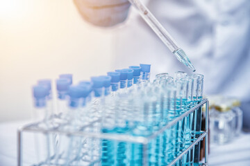medical or scientific researcher researching and experimenting Multi-colored solution, vial and...