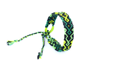 Woven DIY friendship bracelets handmade of embroidery bright thread with knots on white background.