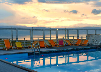 Sun loungers by the pool against the sunset in summer. Lake Baikal, Olkhon
