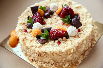 Birthday cake. Garnished with fruits, berries and chocolate. Festive mood. High quality photo
