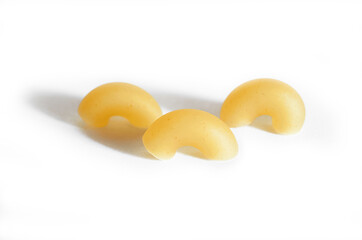 Three macaroni horns isolated on a white background.