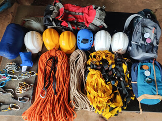 High angled view of organized hiking gear for climbing placed on rustic wooden boards.