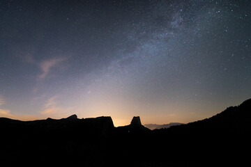 Milky way over the silouhette of mountains
