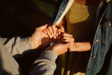 A guy and a girl hold hands