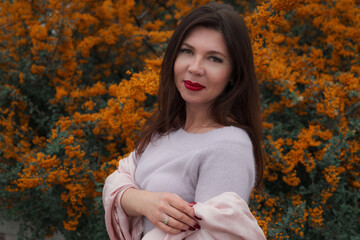 Portrait of a gorgeous middle-aged woman in an autumn park
