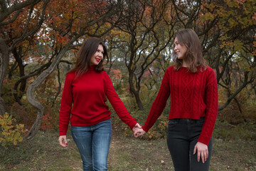 Mature mother hugging with her teen daughter outdoor in nature