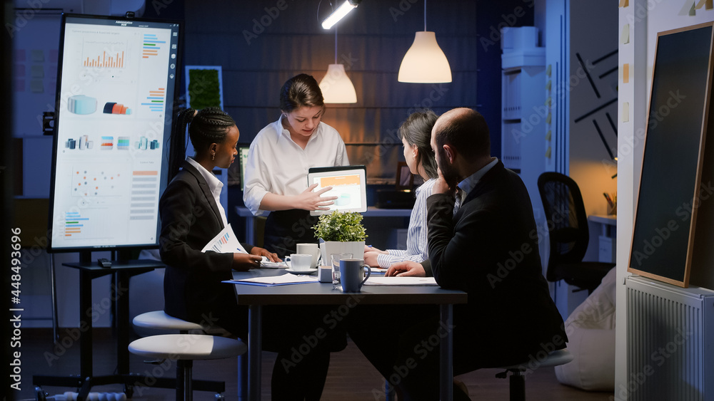 Poster diverse multi-ethnic businesspeople analyzing management graphs using tablet for company presentatio